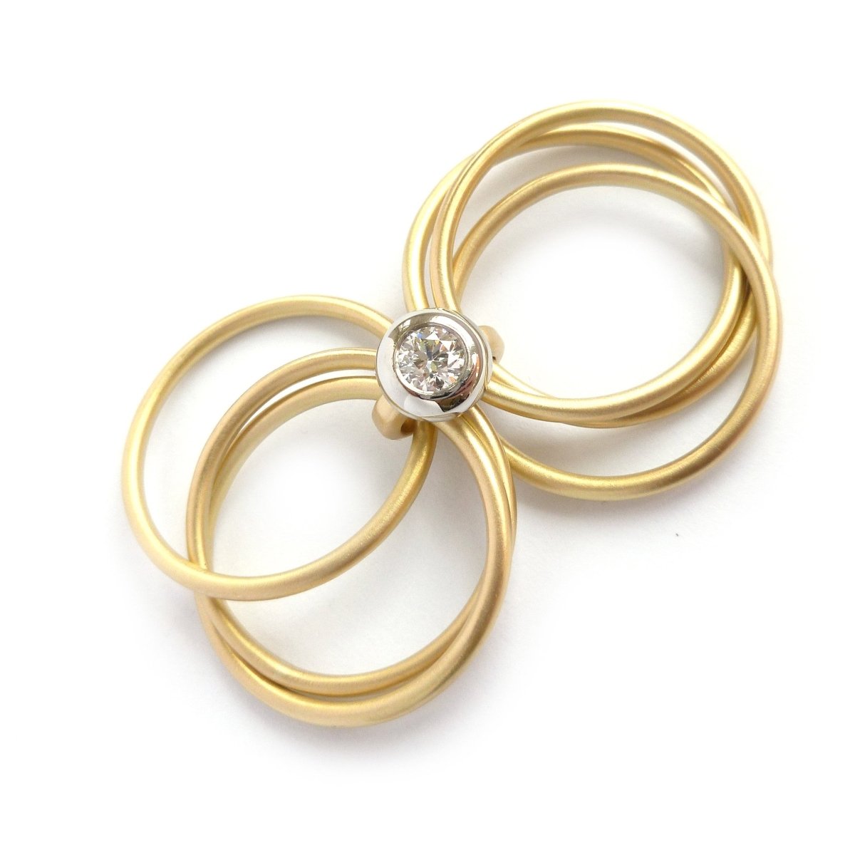 Contemporary, bespoke and modern yellow gold multi band engagement wedding ring, 0.25pt round white diamond, handmade by designer maker sue lane jewellery. Multi band ring or interlocking ring.