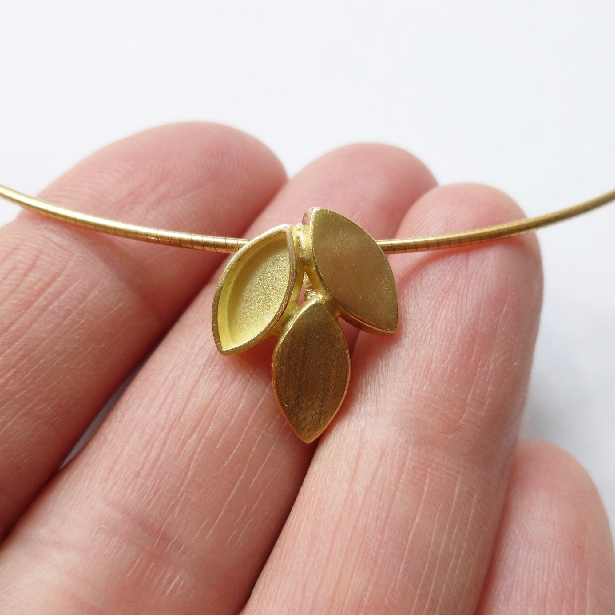 modern and simple yellow gold leaf inspired necklace handmade by Sue Lane UK