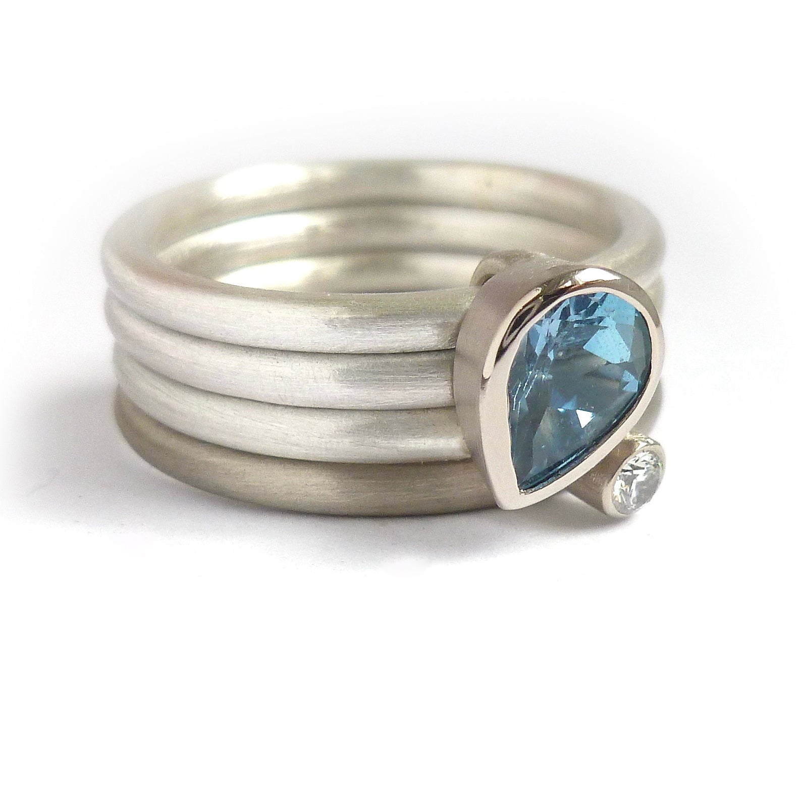 A unique, contemporary aquamarine and diamond gold and silver ring