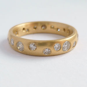 A modern unique eternity ring with 20 diamonds. Beautiful contemporary wedding, eternity or engagement ring.