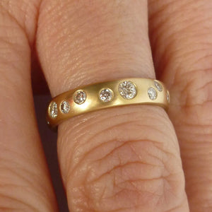 A modern unique eternity ring with 20 diamonds. Beautiful contemporary wedding, eternity or engagement ring.