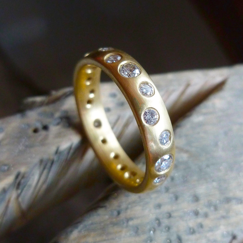 A modern unique eternity ring with 20 diamonds. Beautiful contemporary wedding, eternity or engagement ring.