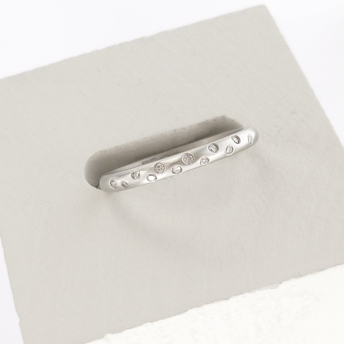 Contemporary, unique, bespoke and modern platinum diamond wedding ring, engagement ring, eternity ring, matt brushed finish. Handmade by designer maker Sue Lane