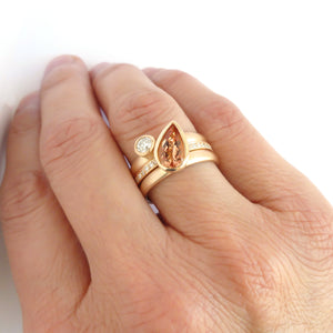 Contemporary rose gold and pear shaped imperial topaz stacking interlocking ring set.