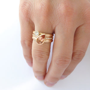 Contemporary rose gold and pear shaped imperial topaz stacking interlocking ring set.