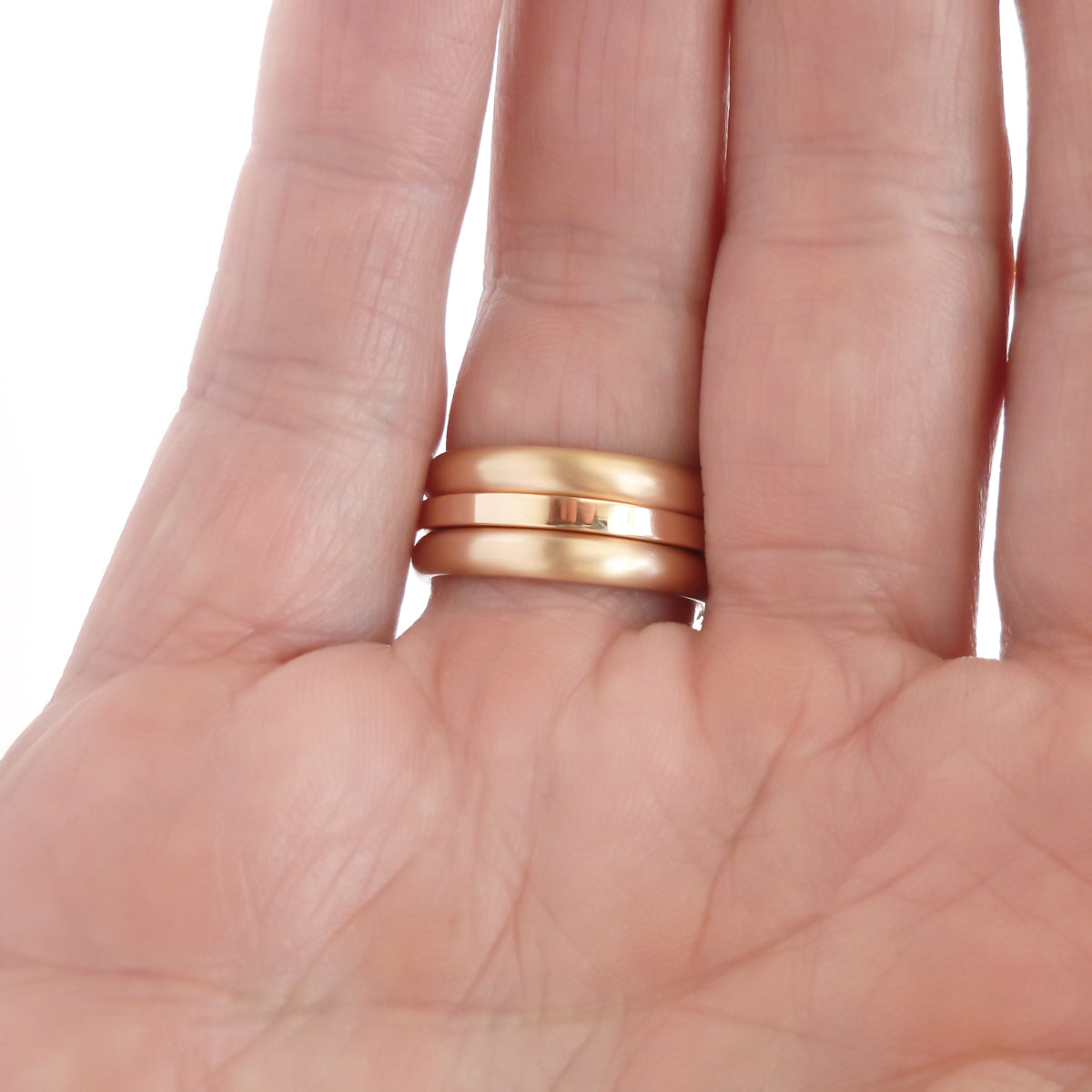 Contemporary rose gold and pear shaped imperial topaz stacking interlocking ring set.