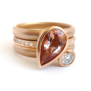 Contemporary rose gold and pear shaped imperial topaz stacking interlocking ring set.