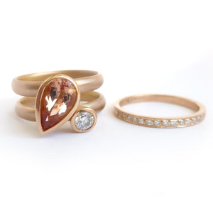 Contemporary rose gold and pear shaped imperial topaz stacking interlocking ring set.