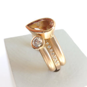 Contemporary rose gold and pear shaped imperial topaz stacking interlocking ring set.