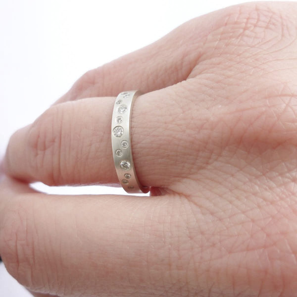 A unique stacking silver ring with 10 diamonds and a matt finish by Sue Lane