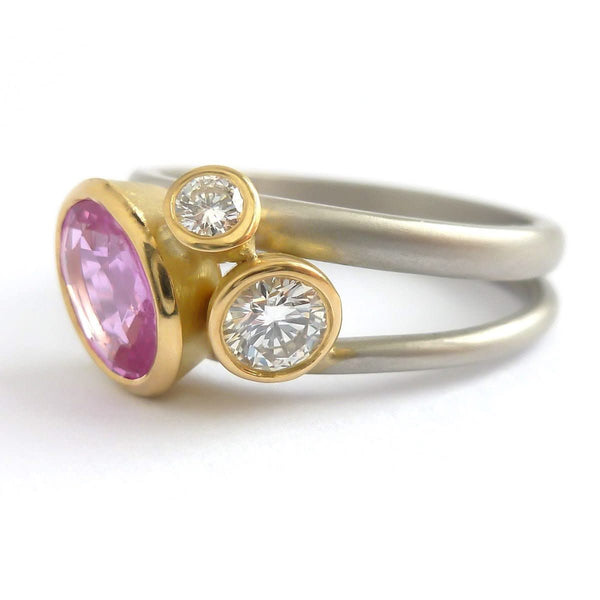 Platinum, 18ct gold, pink sapphire and two white diamonds ring. Contemporary, modern and unique.