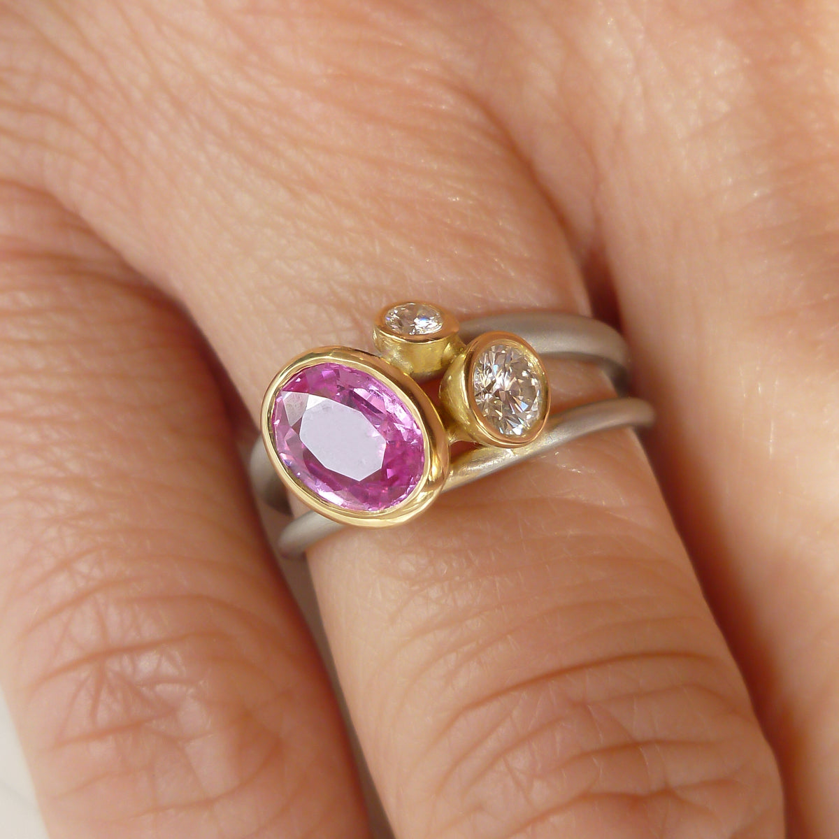 Platinum, 18ct gold, pink sapphire and two white diamonds ring. Contemporary, modern and unique.