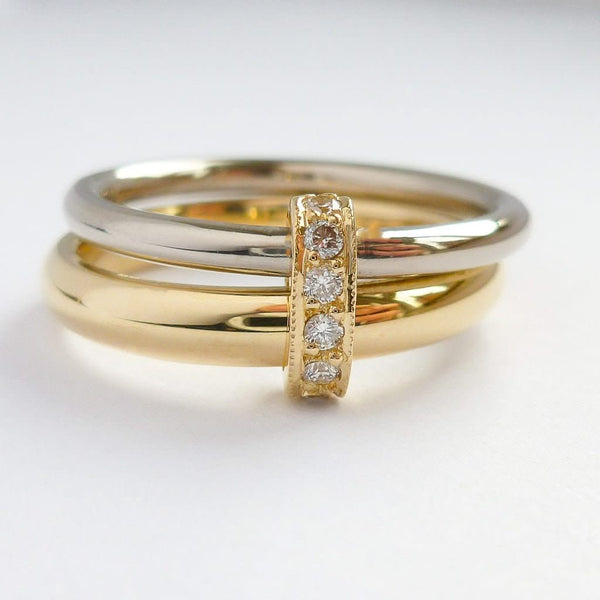 Two band 18ct yellow and white gold ring with diamonds. Contemporary, modern. Multi band ring or interlocking ring, sometimes called double band ring too.
