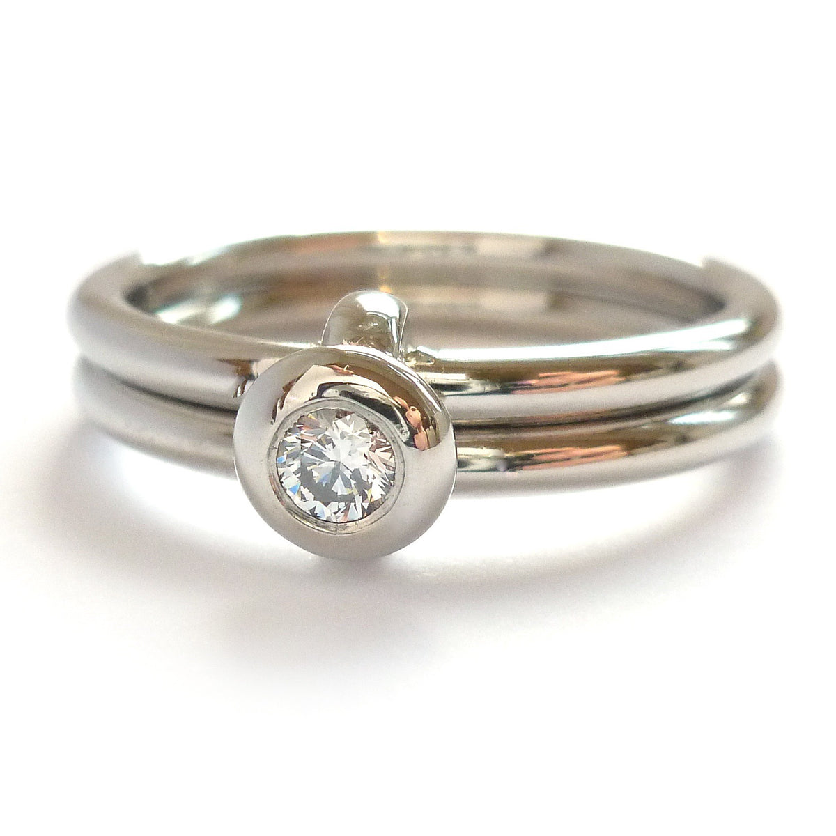 Contemporary platinum two band engagement ring with diamond. Bespoke. Multi band ring or interlocking ring, sometimes called double band ring too.