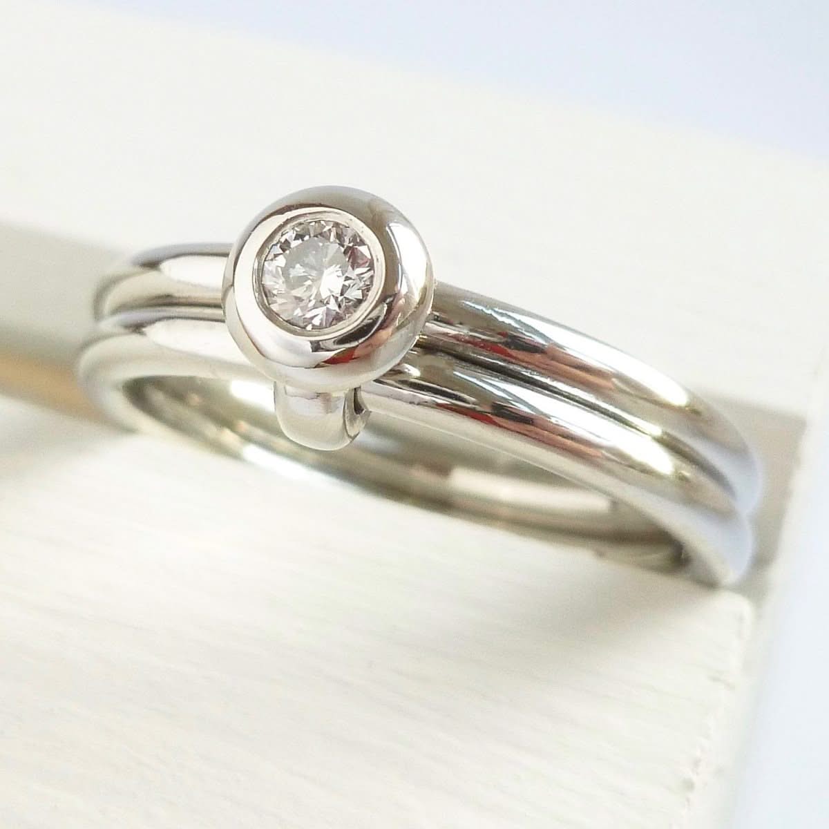 Contemporary platinum two band engagement ring with diamond. Bespoke. Multi band ring or interlocking ring, sometimes called double band ring too.