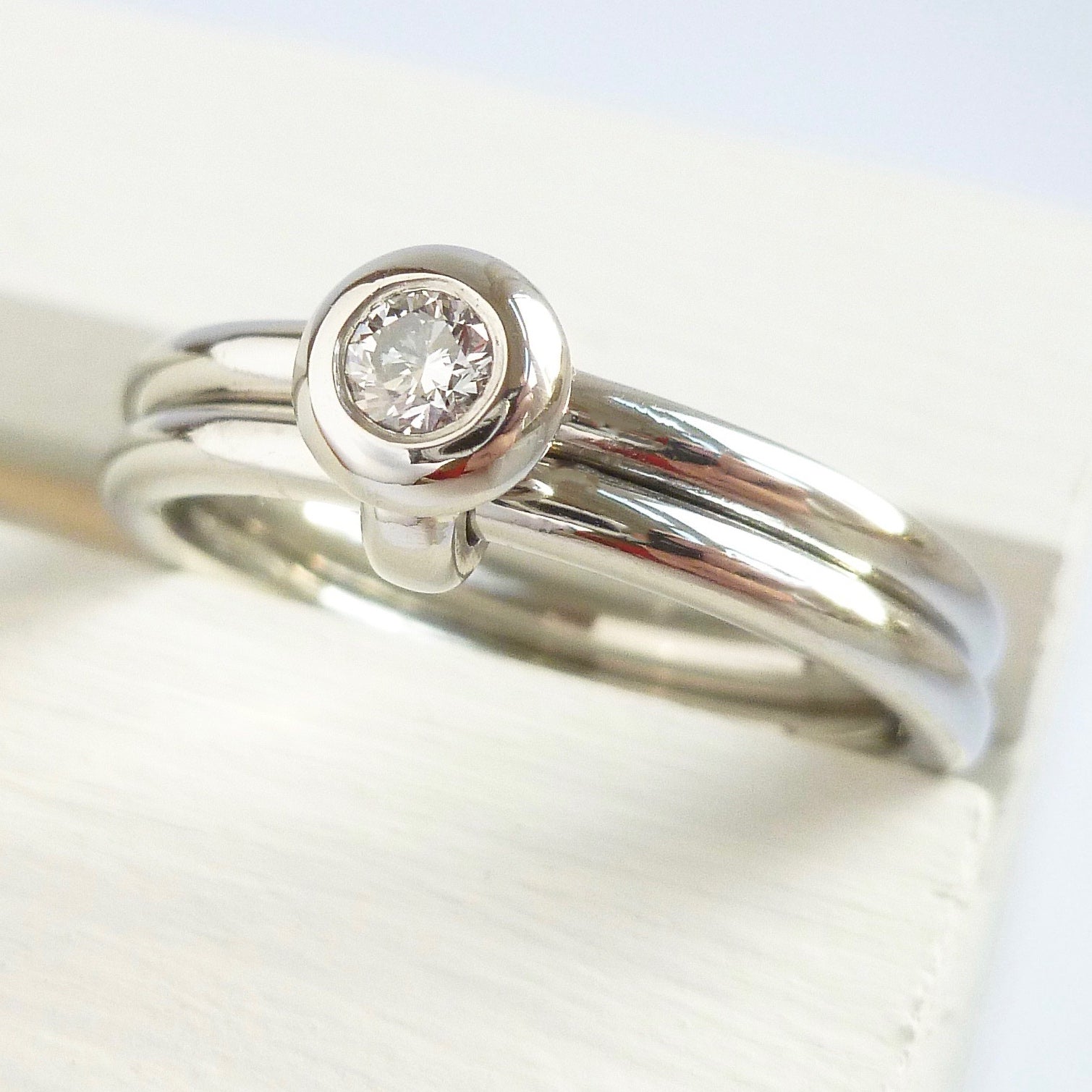 Contemporary platinum two band engagement ring with diamond. Bespoke. Multi band ring or interlocking ring, sometimes called double band ring too.