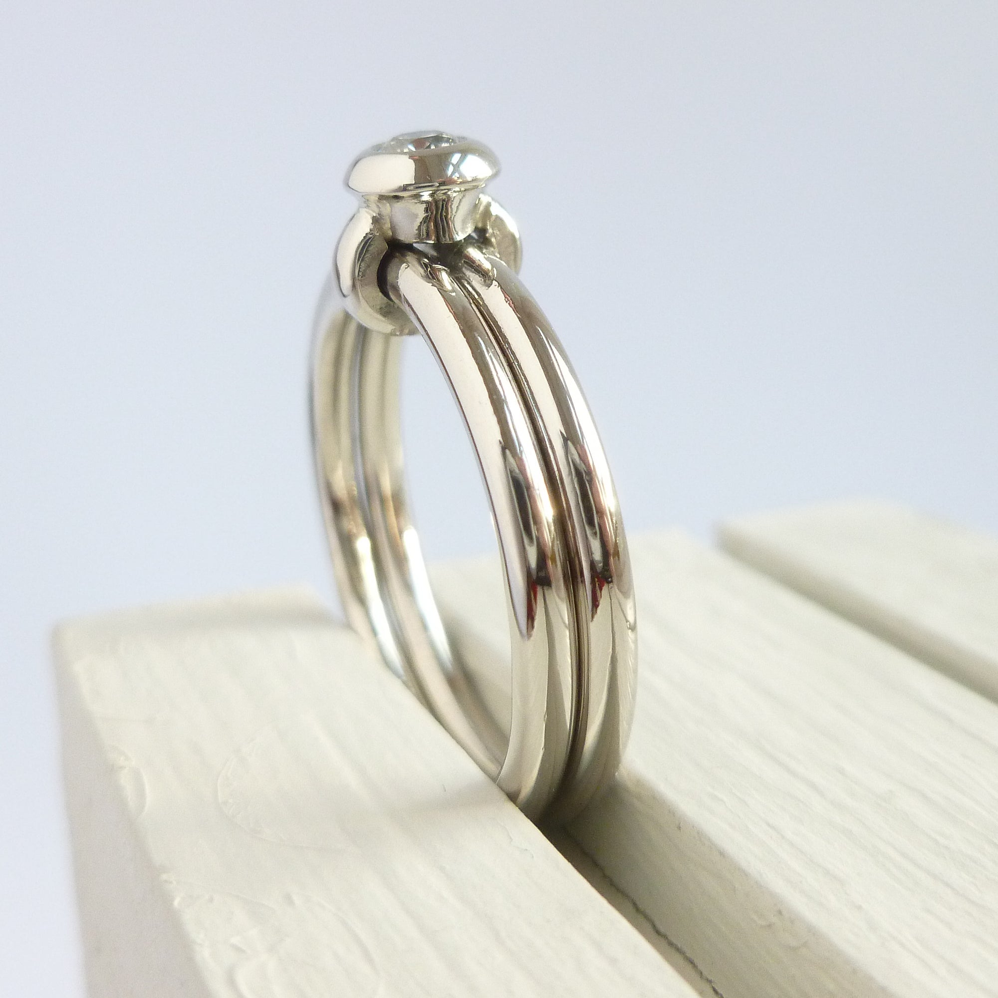 Contemporary platinum two band engagement ring with diamond. Bespoke. Multi band ring or interlocking ring, sometimes called double band ring too.