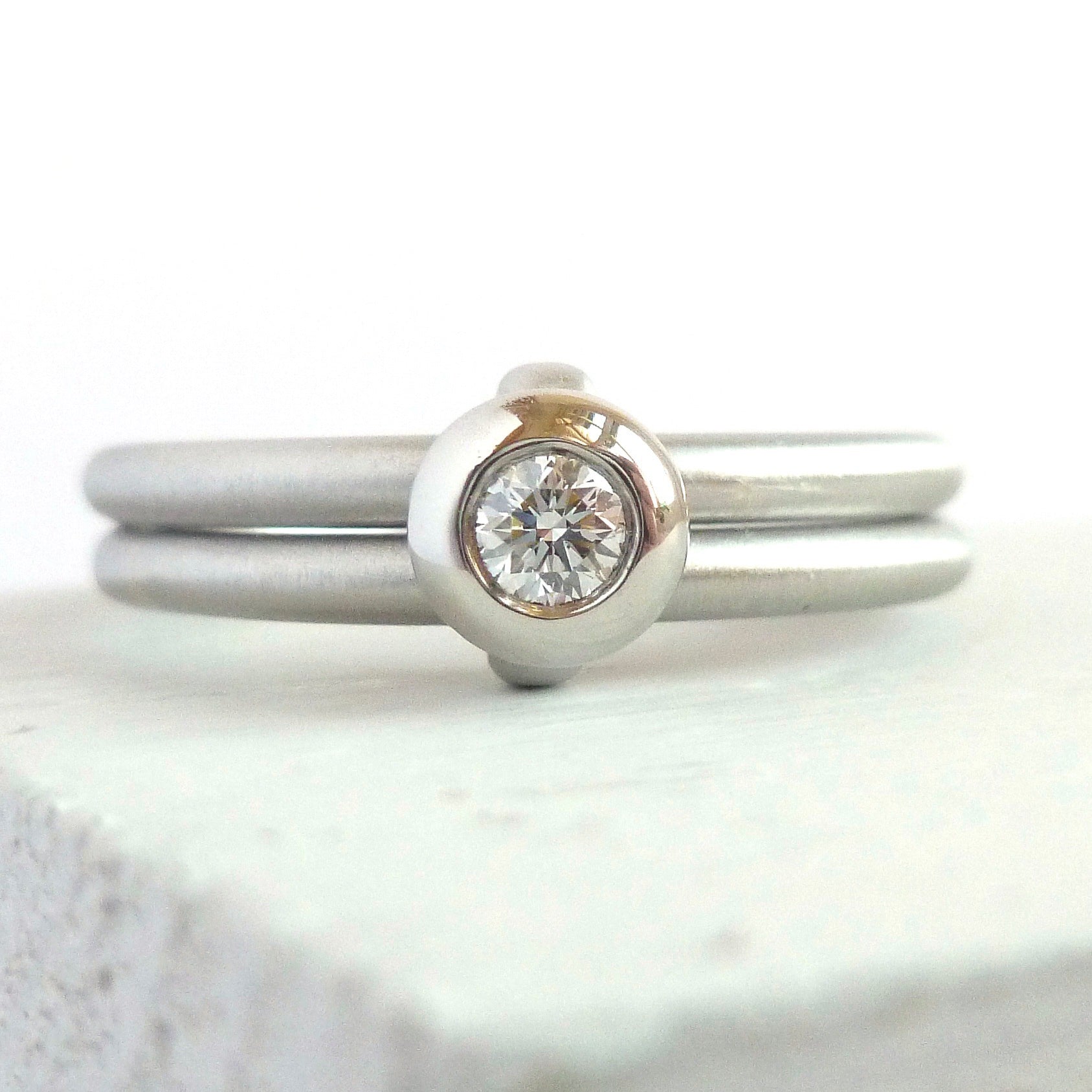Contemporary platinum two band engagement ring with diamond. Bespoke. Multi band ring or interlocking ring, sometimes called double band ring too.