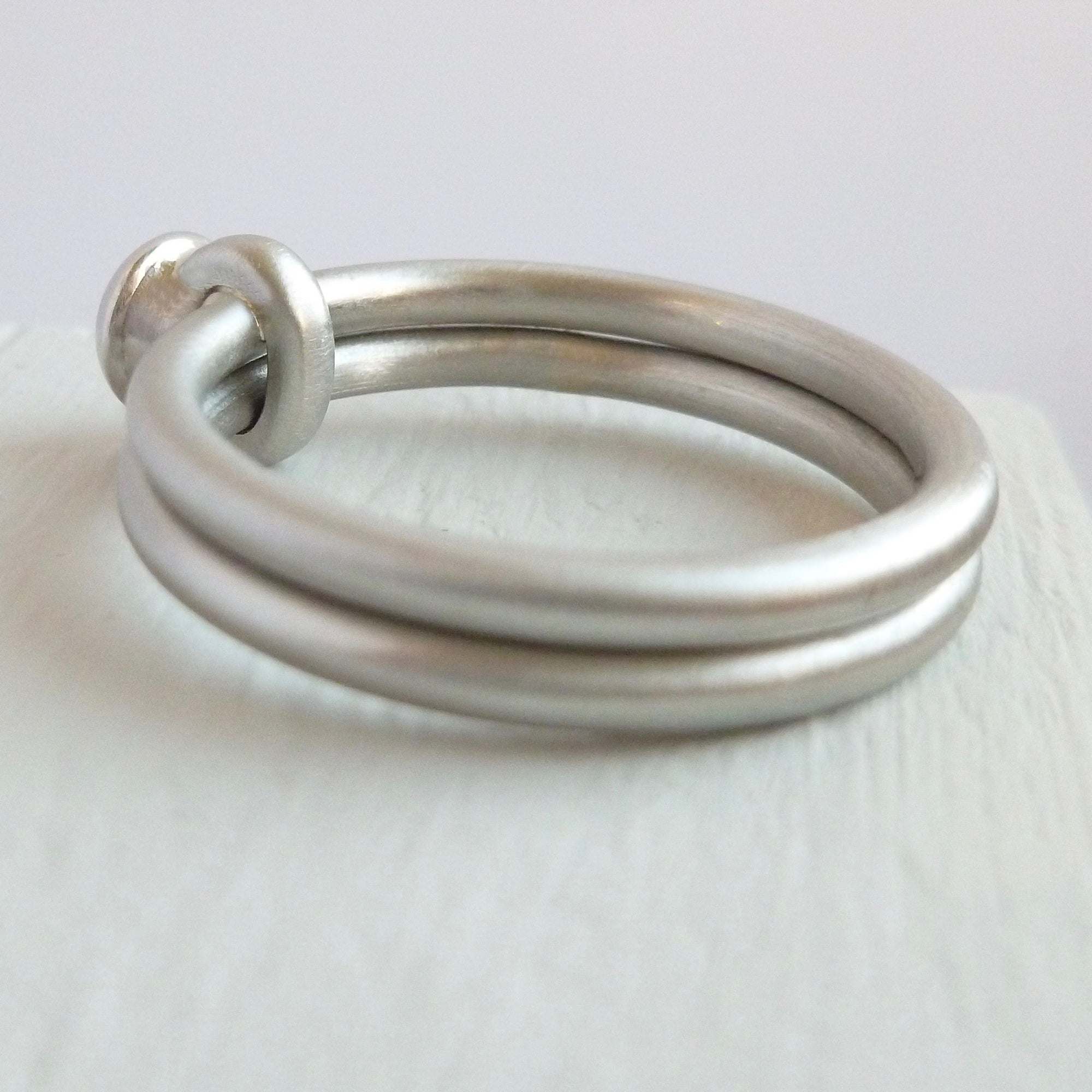 Contemporary platinum two band engagement ring with diamond. Bespoke. Multi band ring or interlocking ring, sometimes called double band ring too.