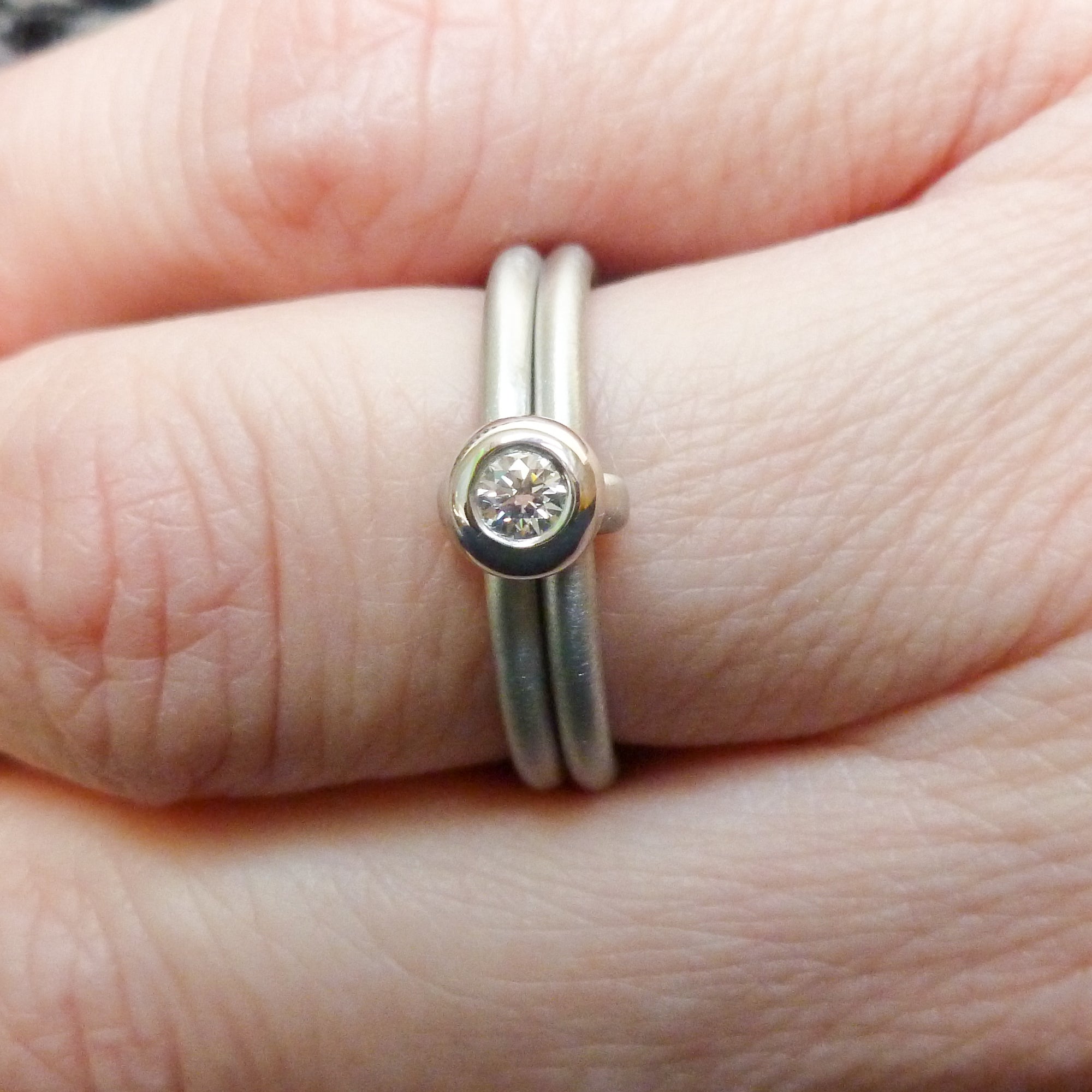 Contemporary platinum two band engagement ring with diamond. Bespoke. Multi band ring or interlocking ring, sometimes called double band ring too.