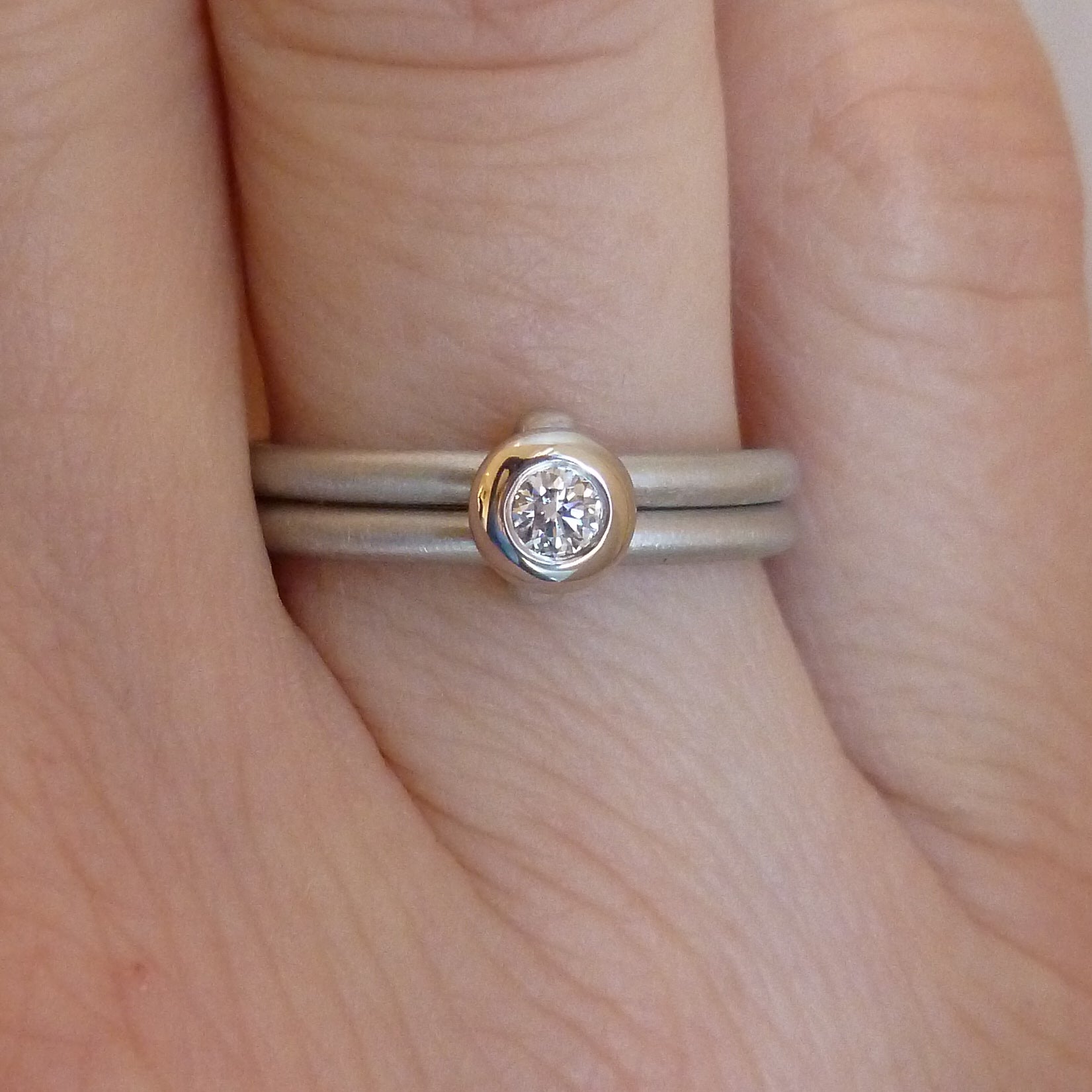 Contemporary platinum two band engagement ring with diamond. Bespoke. Multi band ring or interlocking ring, sometimes called double band ring too.