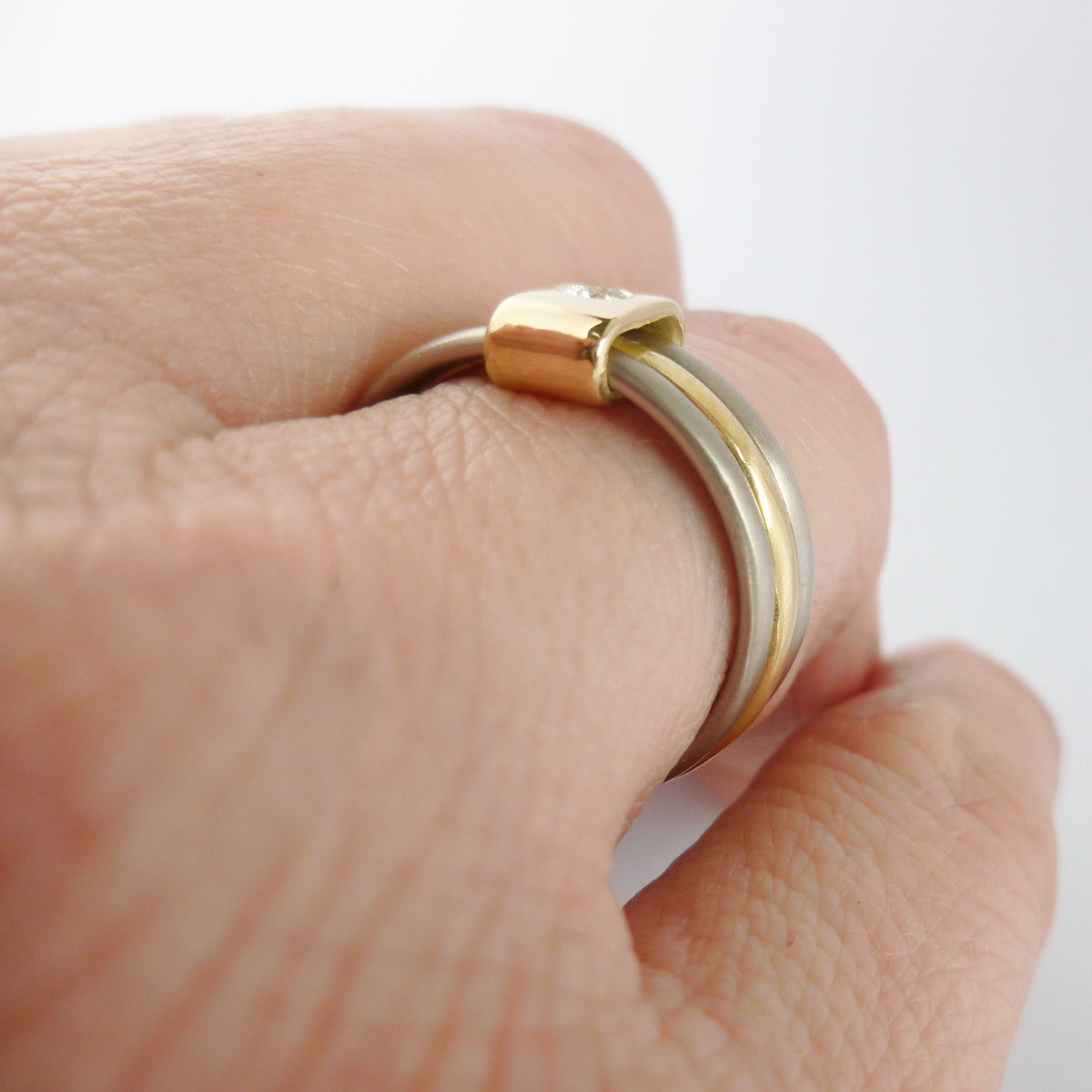 Contemporary jewellery, handmade, modern, bespoke ring by Sue Lane. Triple band ring, interlocking and linked.