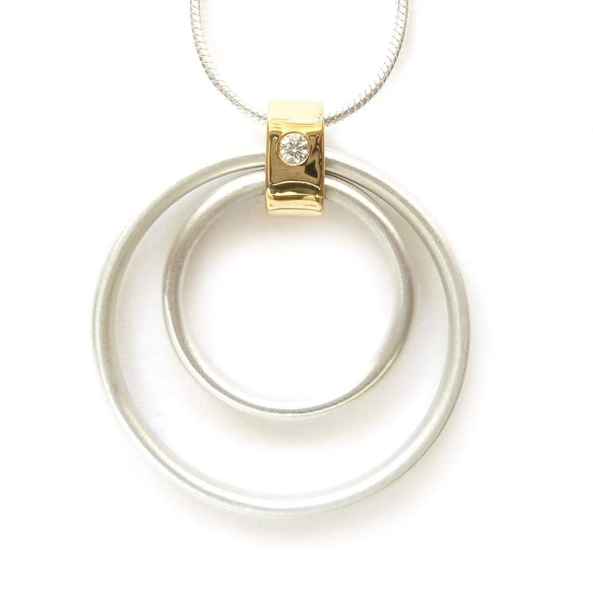 Contemporary handmade sterling silver and 18ct gold pendant with a diamond on a silver snake chain.