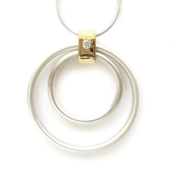 Contemporary handmade sterling silver and 18ct gold pendant with a diamond on a silver snake chain.