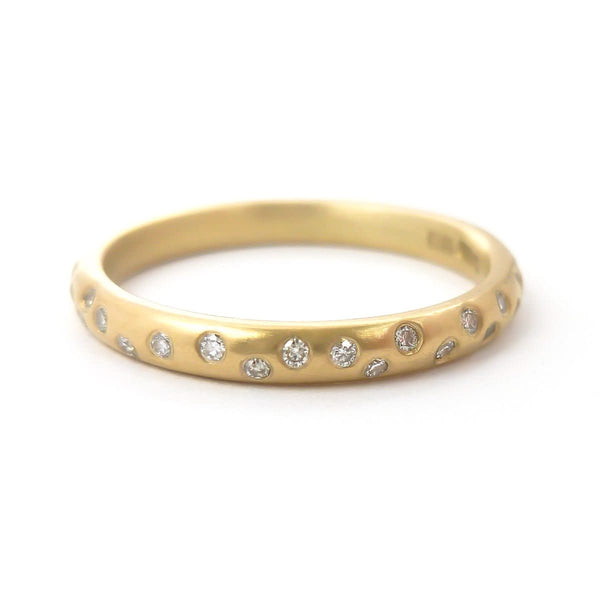 A modern, contemporary gold eternity ring, wedding ring, or engagement ring