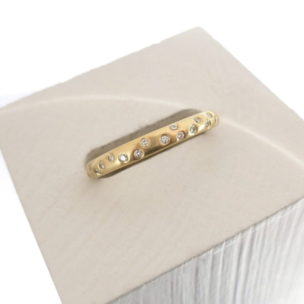 A modern, contemporary gold eternity ring, wedding ring, or engagement ring