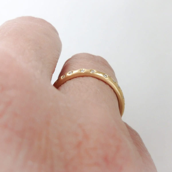 A modern, contemporary gold eternity ring, wedding ring, or engagement ring
