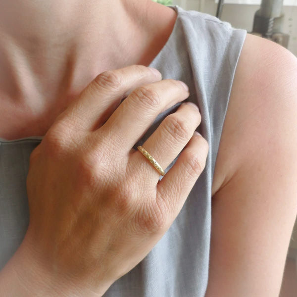 A modern, contemporary gold eternity ring, wedding ring, or engagement ring