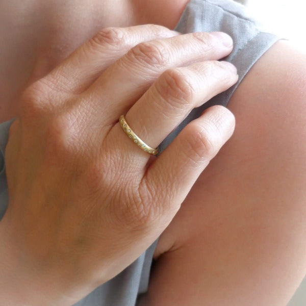 A modern, contemporary gold eternity ring, wedding ring, or engagement ring