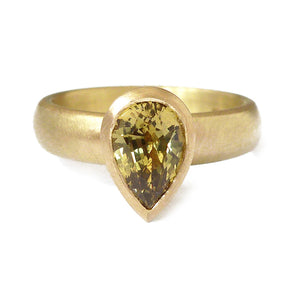 Unusual, bespoke and modern gold and pear shape green/yellow sapphire dress or engagement ring handmade by designer maker Sue Lane contemporary Jewellery, UK