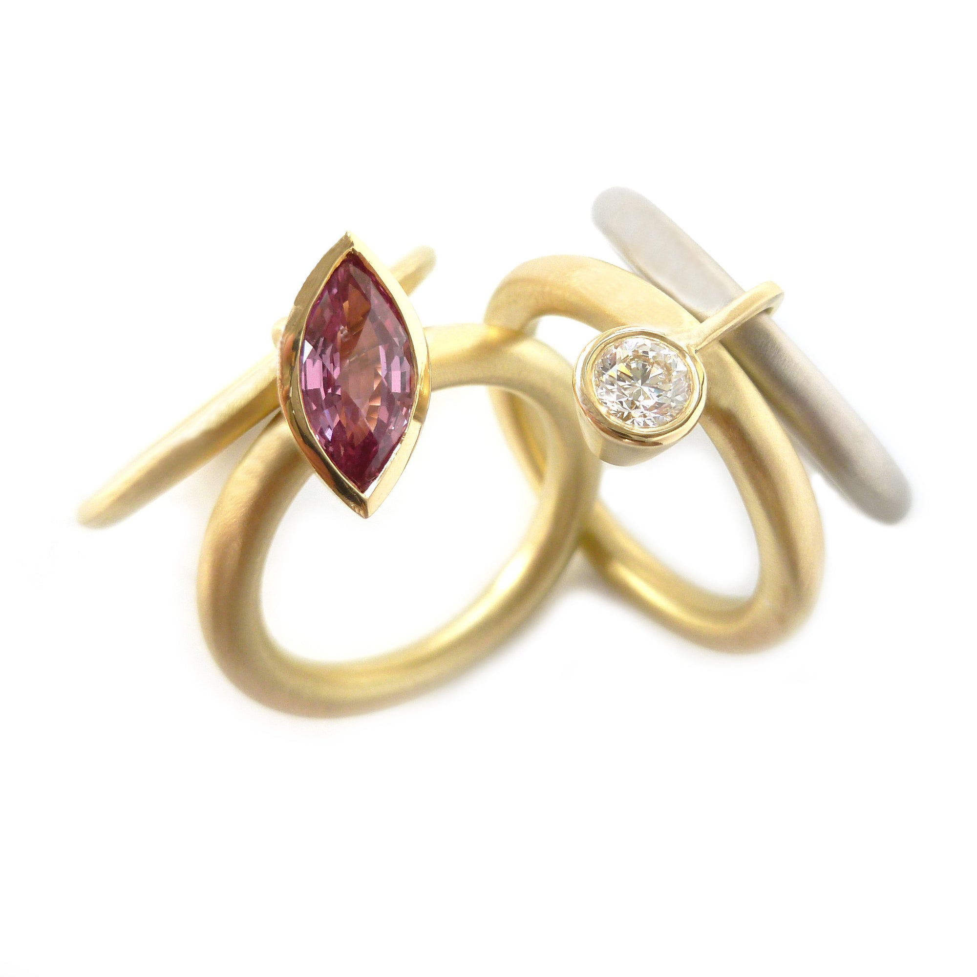 Unusual, unique, bespoke and modern statement gold and marquise pink sapphire stacking ring set handmade by designer maker Sue Lane contemporary Jewellery, UK