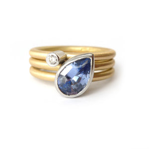 Unique, bespoke and modern statement platinum and gold and pear shape cornflower blue sapphire stacking ring set handmade by designer maker Sue Lane Jewellery