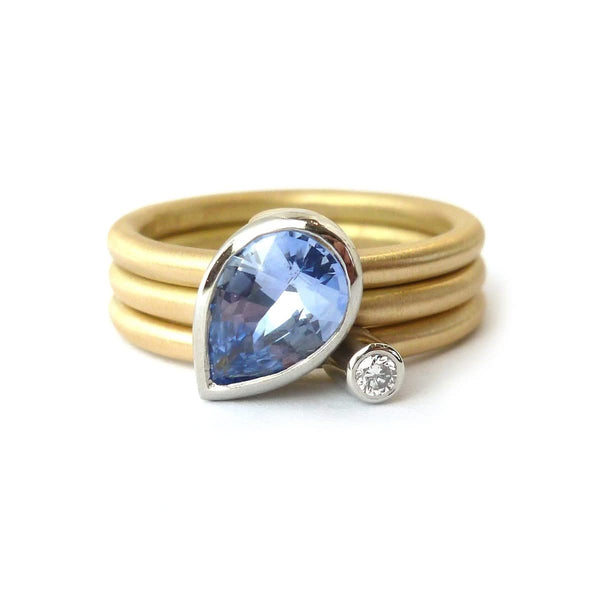 Unique, bespoke and modern statement platinum and gold and pear shape cornflower blue sapphire stacking ring set handmade by designer maker Sue Lane Jewellery