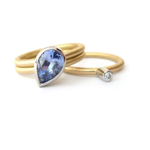 Unique, bespoke and modern statement platinum and gold and pear shape cornflower blue sapphire stacking ring set handmade by designer maker Sue Lane Jewellery
