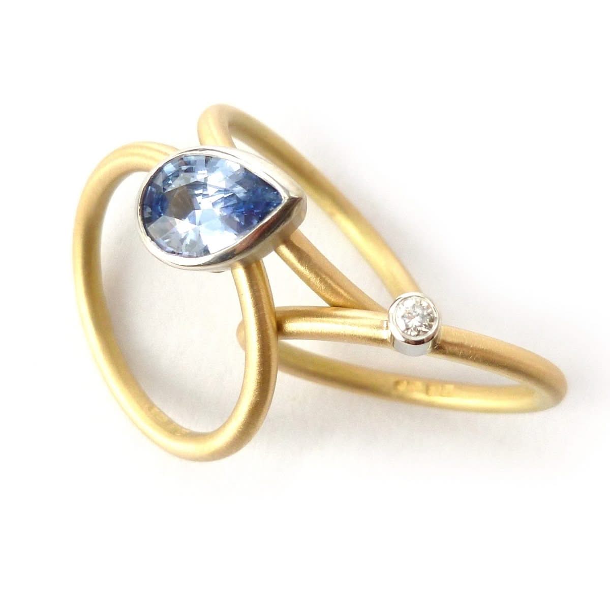 Unique, bespoke and modern statement platinum and gold and pear shape cornflower blue sapphire stacking ring set handmade by designer maker Sue Lane Jewellery