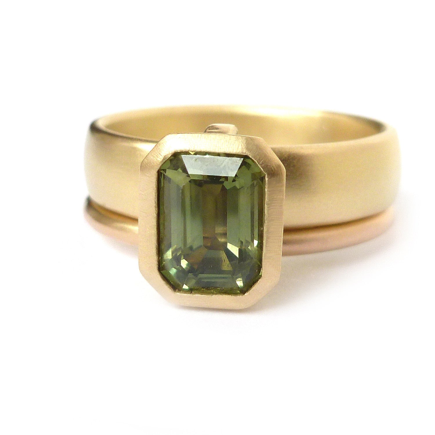 Unique, modern and contemporary two band ring,with a green sapphire. Perfect for a alternative wedding and engagement ring. Handmade in UK by designer Sue Lane.