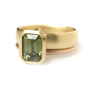 Unique, modern and contemporary two band ring,with a green sapphire. Perfect for a alternative wedding and engagement ring. Handmade in UK by designer Sue Lane.