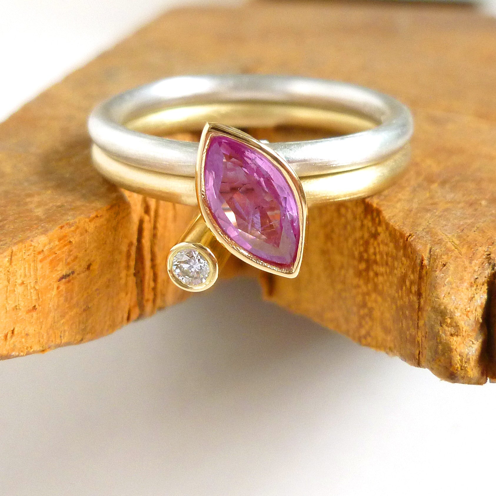Modern gold and silver two band ring with marquise pink sapphire