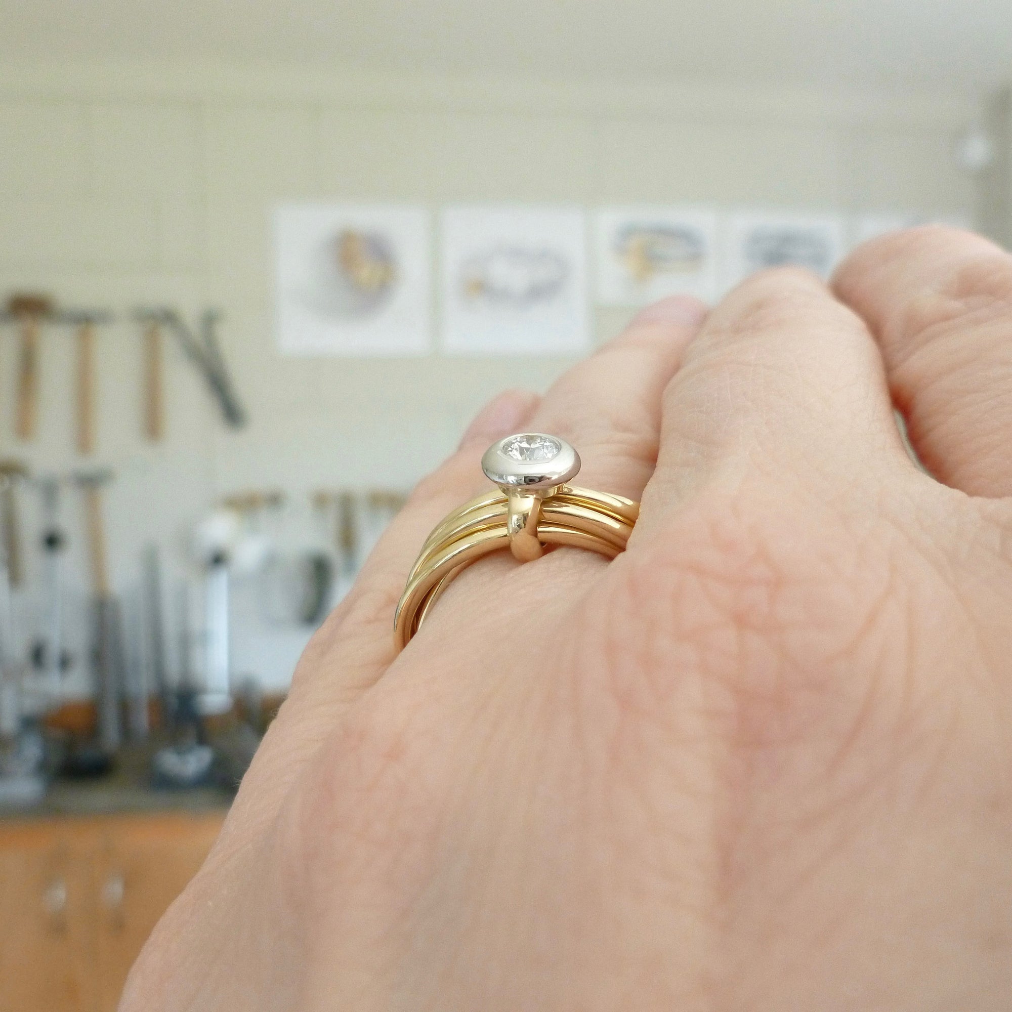 bespoke gold and diamond wedding and engagement ring in one. Multi band ring or interlocking ring.