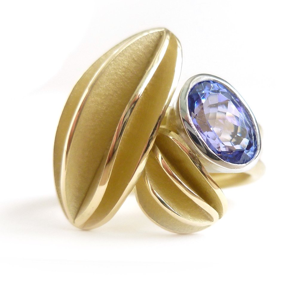 contemporary gold platinum and tanzanite ring with gold leaf shape detail