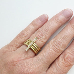 A heavy weight modern four band stacking gold ring with a row of pave diamonds. Multi band ring or interlocking ring.