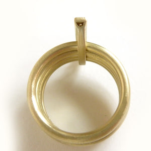 A contemporary chunky modern four band stacking gold ring with a row of pave diamonds. Multi band ring or interlocking ring.