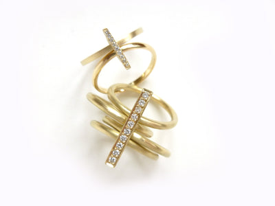 contemporary yellow gold and diamond 4 band stacking rings with a brushed finish. Multi band ring or interlocking ring.