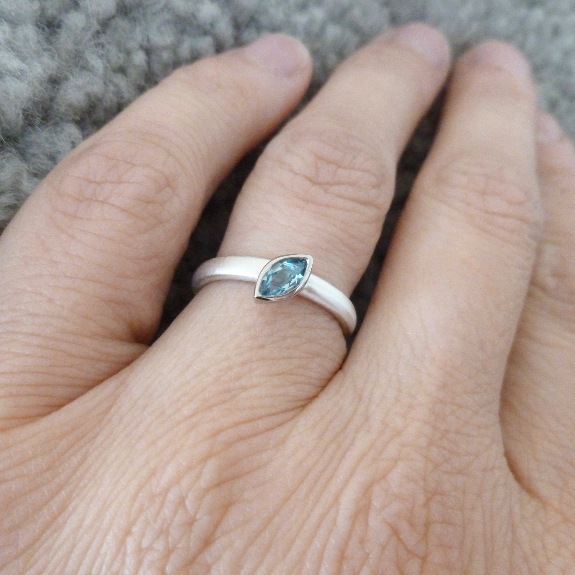 modern silver and aquamarine stacking ring with brushed finish