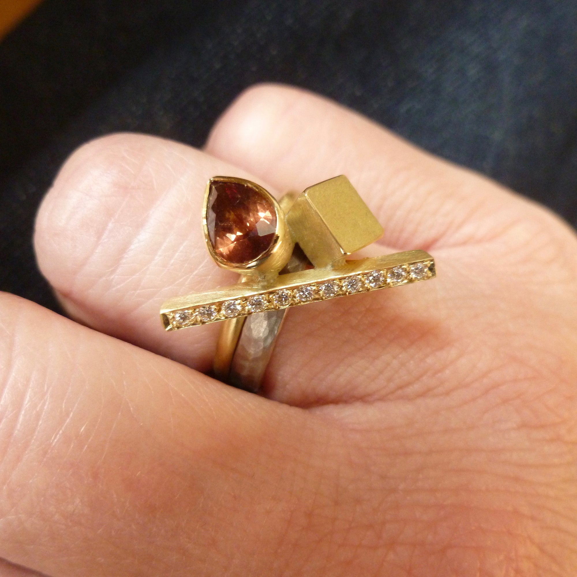 one of contemporary gold, diamond and colour change garnet ring