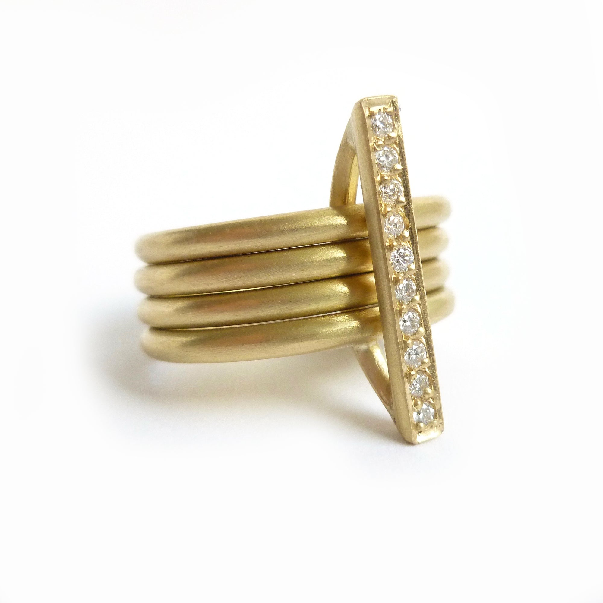 contemporary yellow gold and diamond 4 band stacking rings with a brushed finish. Multi band ring or interlocking ring.